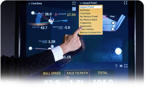 Close-up of a golfer's hand interacting with the RangeX touchscreen interface to view club path and impact data.