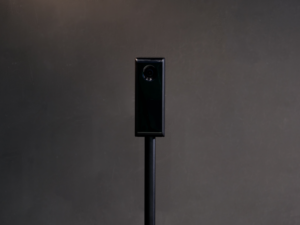 The tall, black RangeX dual camera tower positioned in the simulator bay to capture high-speed swing video.